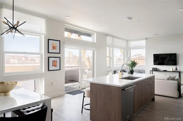 a living room with furniture a flat screen tv and a large window