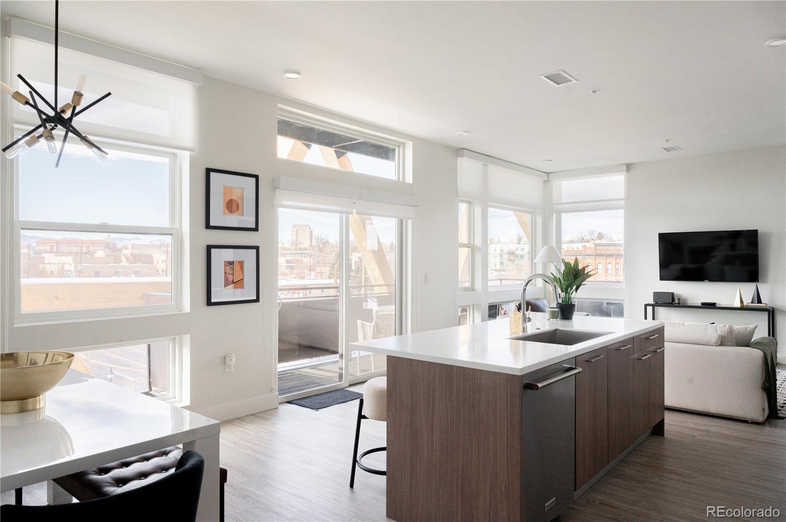 2880 Zuni Street, Unit 404 Denver, CO 80211 - Photo 8 of 30 a living room with furniture a flat screen tv and a large window