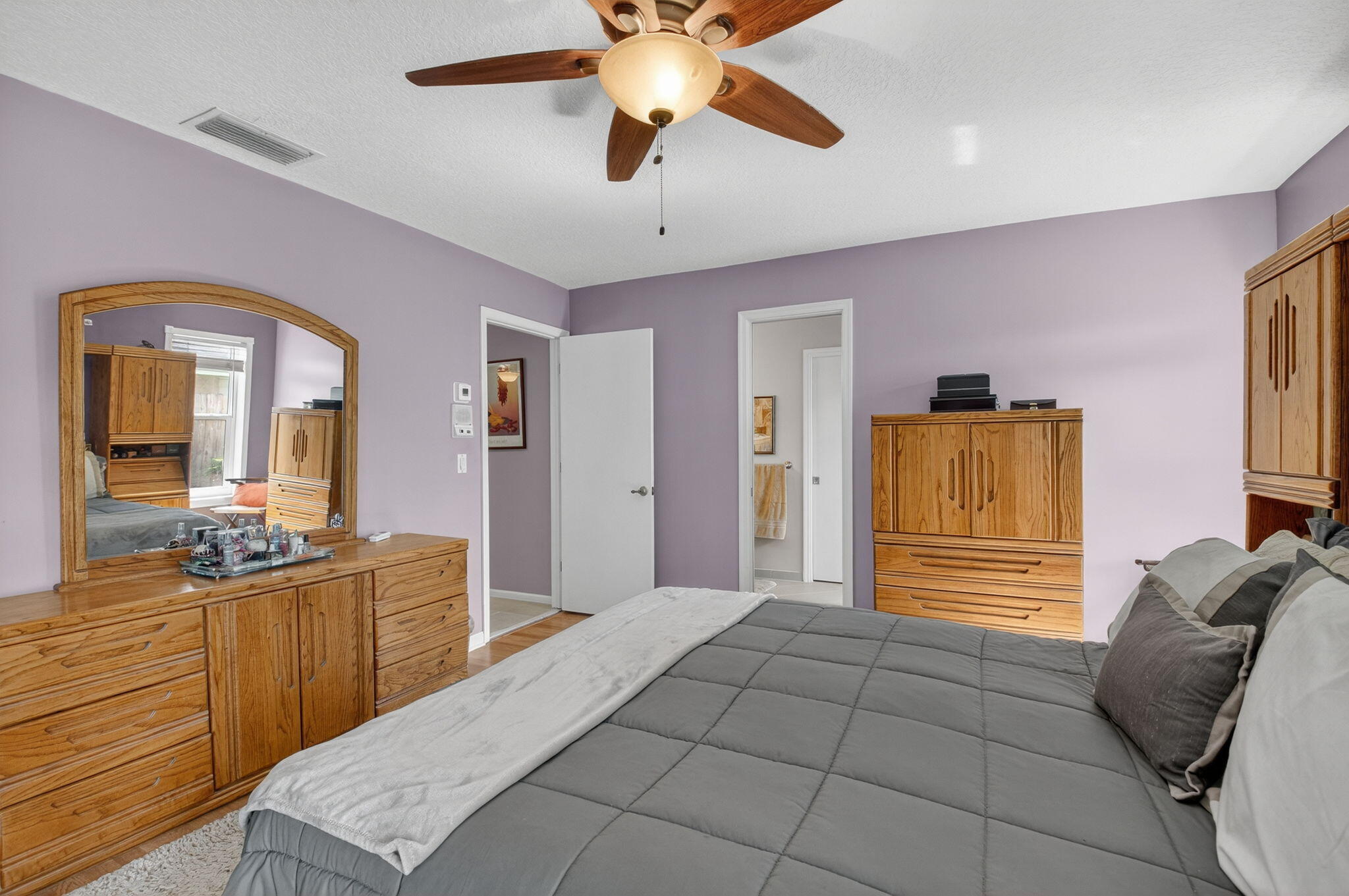 17705 Maplewood Drive Boca Raton, FL 33487 - Photo 32 of 71 a bedroom with a bed and ceiling fan