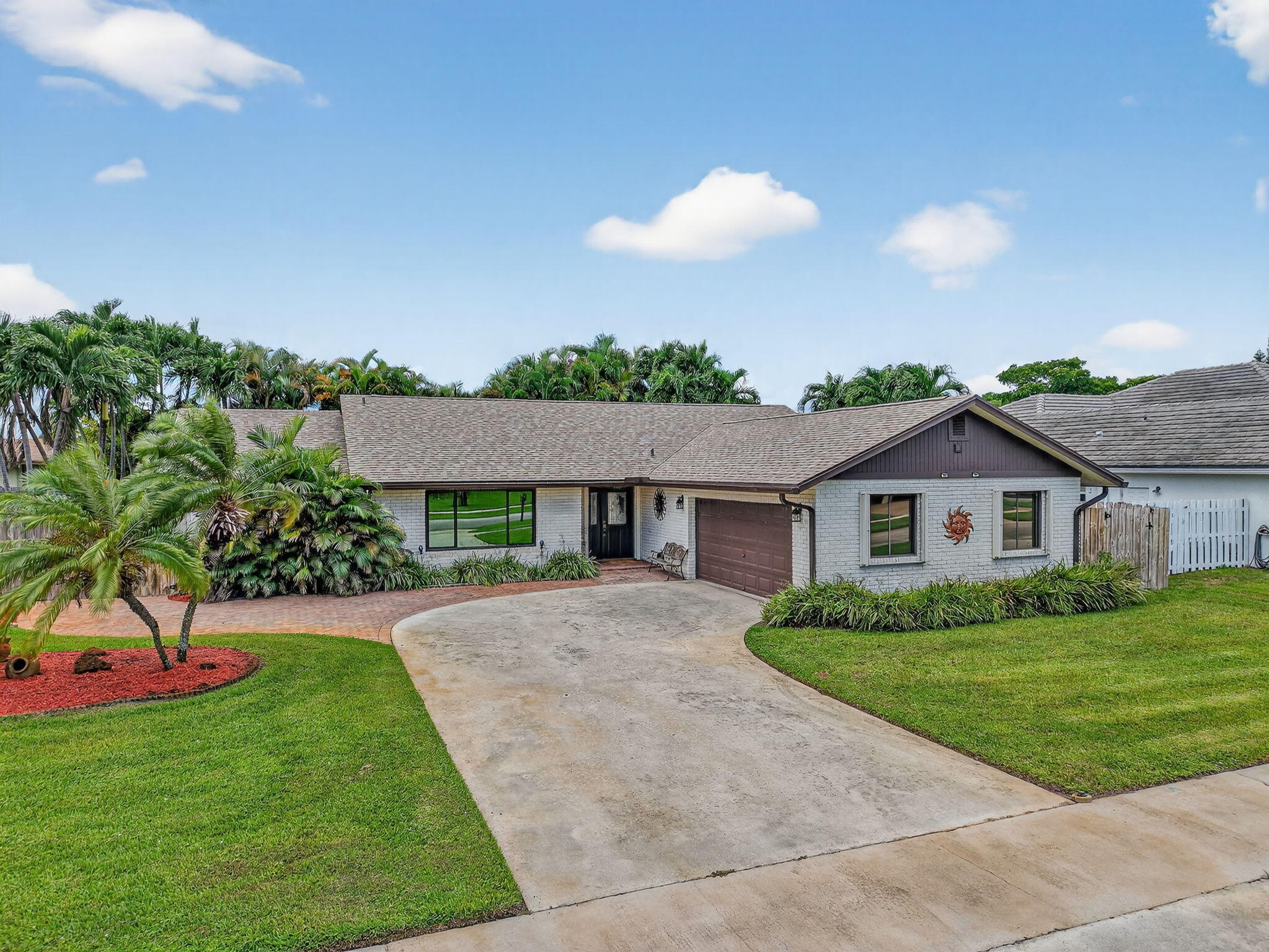 17705 Maplewood Drive Boca Raton, FL 33487 - Photo 48 of 71 a view of a house with a big yard and potted plants