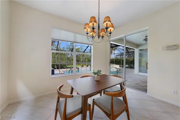 a view of a dining room with furniture wooden floor and chandelier