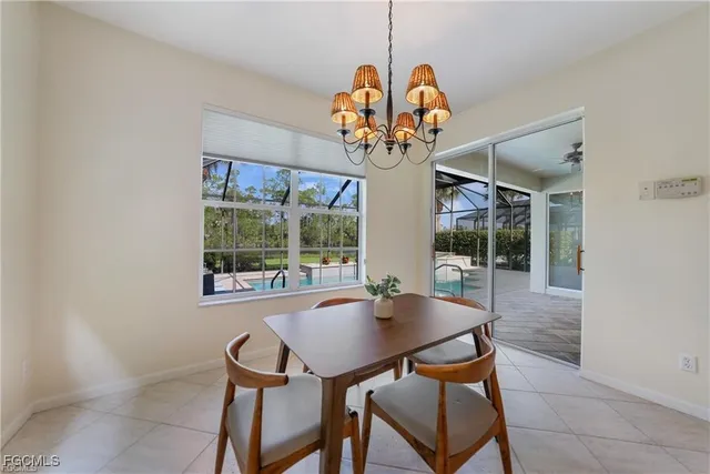 a view of a dining room with furniture wooden floor and chandelier