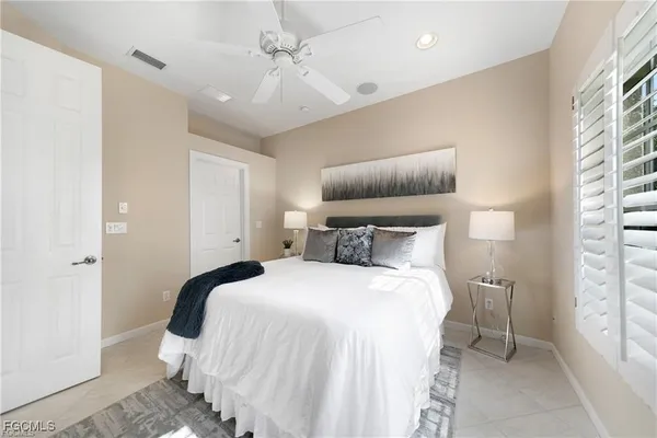 a bedroom with bed and window