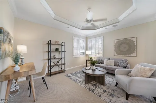a living room with furniture a chandelier and a dining room