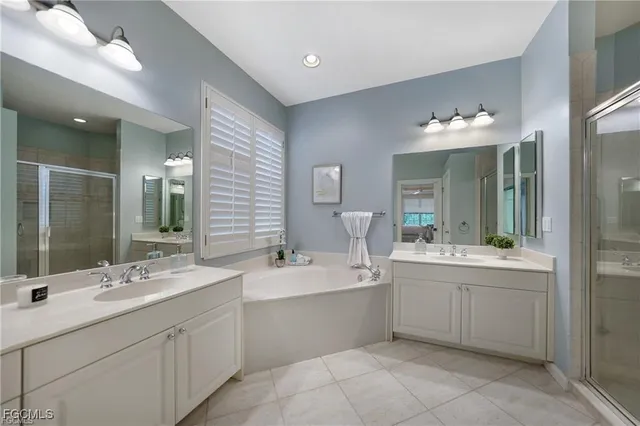 a bathroom with a double vanity sink mirror and