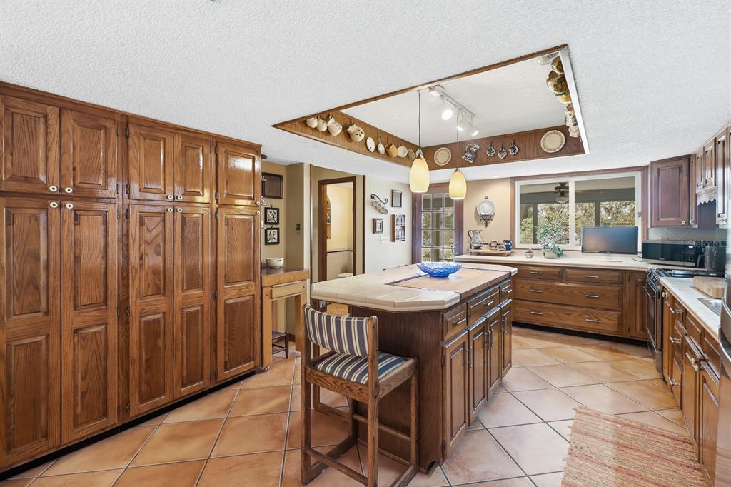 6491 Spruce Creek Road Port Orange, FL 32127 - Photo 11 of 73 a kitchen that has a lot of cabinets in it