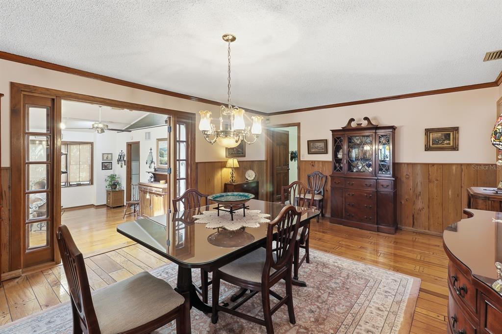 6491 Spruce Creek Road Port Orange, FL 32127 - Photo 15 of 73 a view of a dining room with furniture window and wooden floor