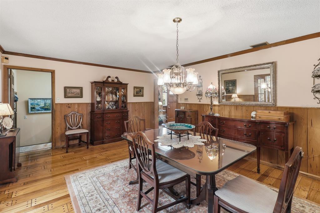 6491 Spruce Creek Road Port Orange, FL 32127 - Photo 17 of 73 a view of a dining room with furniture window and wooden floor