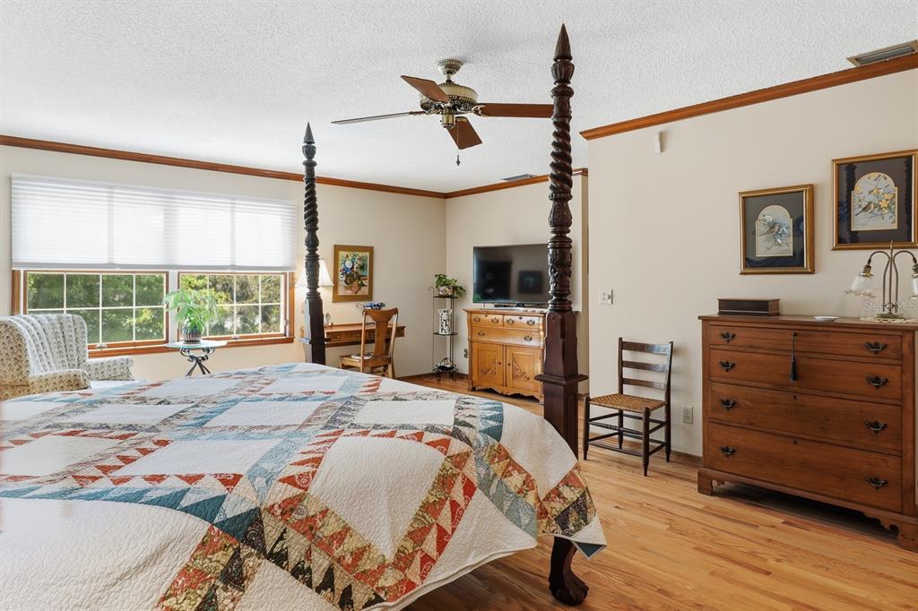 6491 Spruce Creek Road Port Orange, FL 32127 - Photo 20 of 73 a bedroom with a bed flat screen tv and a window