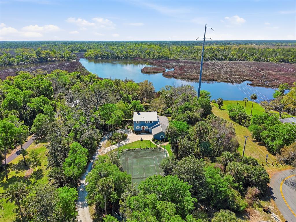 6491 Spruce Creek Road Port Orange, FL 32127 - Photo 2 of 73 an aerial view of a house with a yard and lake view