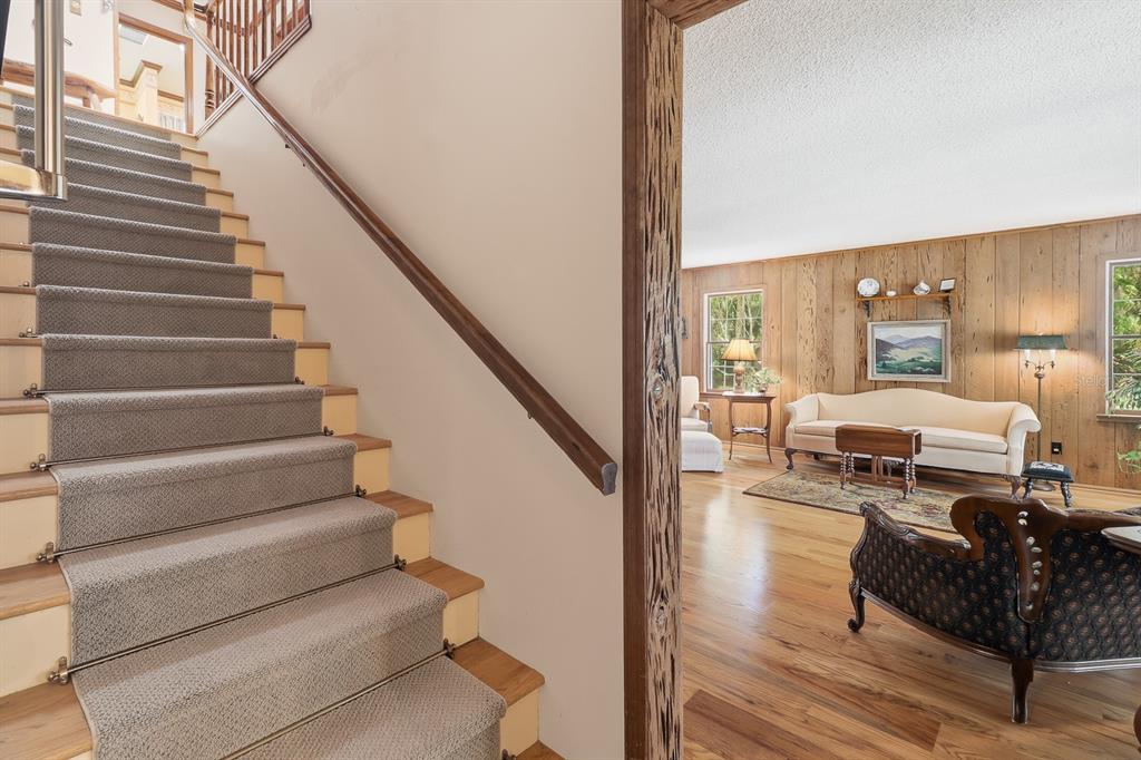 6491 Spruce Creek Road Port Orange, FL 32127 - Photo 23 of 73 a living room with furniture and stairs