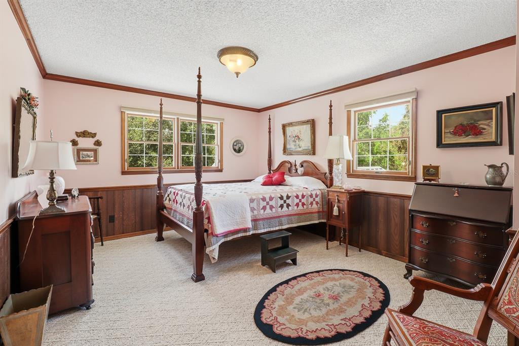 6491 Spruce Creek Road Port Orange, FL 32127 - Photo 26 of 73 a bedroom with a bed and wooden floor