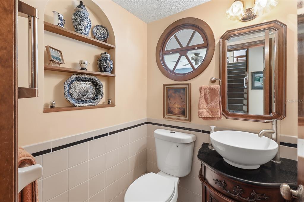 6491 Spruce Creek Road Port Orange, FL 32127 - Photo 30 of 73 a bathroom with a toilet a sink and mirror