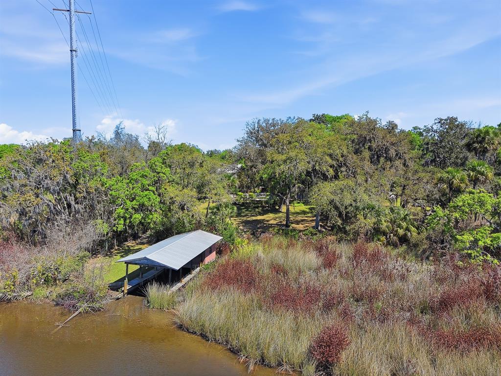 6491 Spruce Creek Road Port Orange, FL 32127 - Photo 3 of 73 a view of a lake with a yard