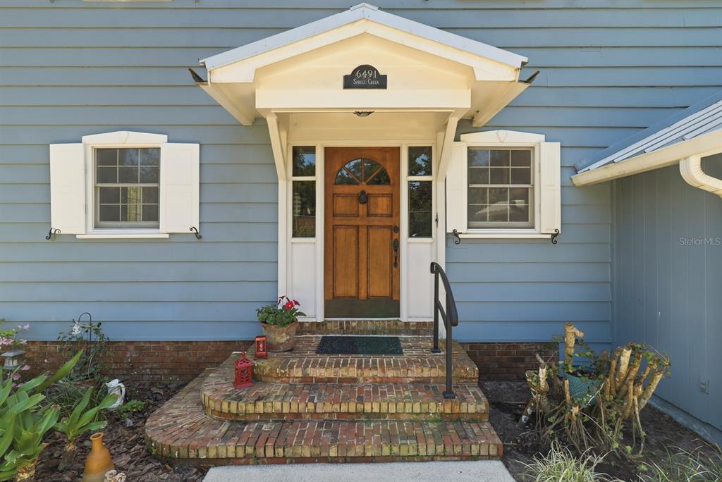 6491 Spruce Creek Road Port Orange, FL 32127 - Photo 4 of 73 a front view of a house with a outdoor seating