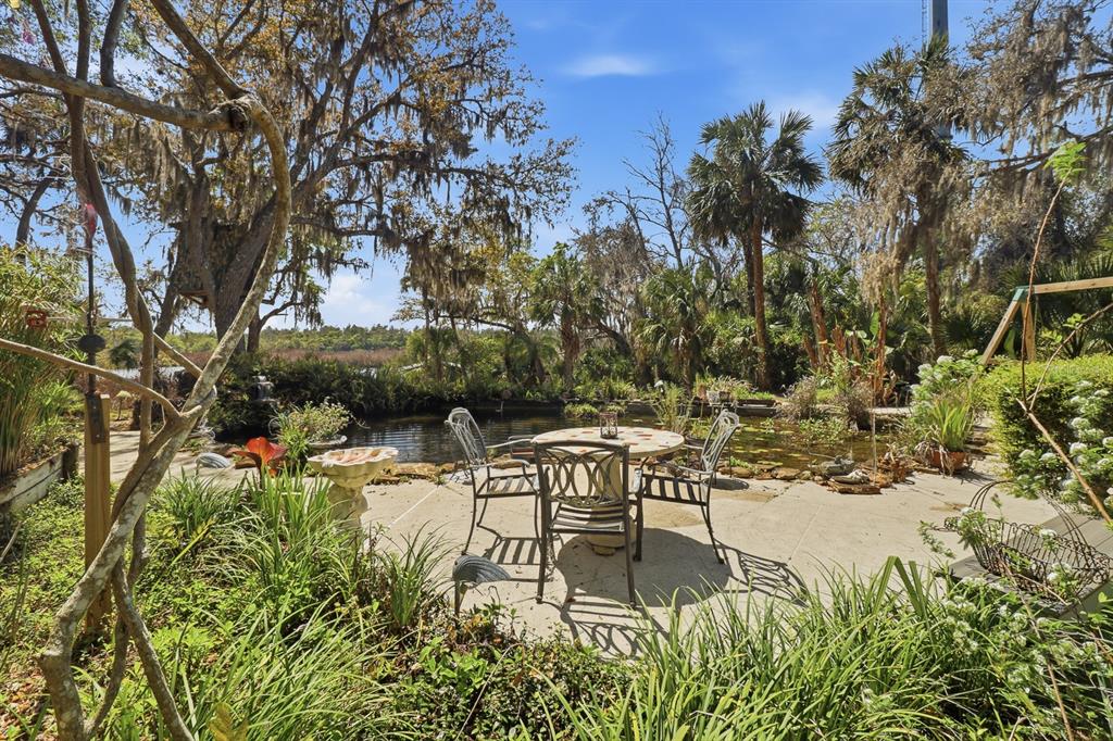 6491 Spruce Creek Road Port Orange, FL 32127 - Photo 41 of 73 a view of swimming pool with table and chairs