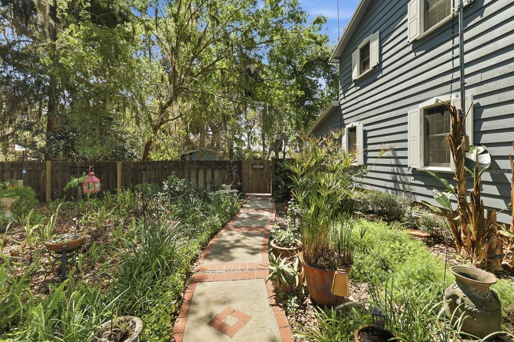 6491 Spruce Creek Road Port Orange, FL 32127 - Photo 47 of 73 a backyard of a house with a garden and plants