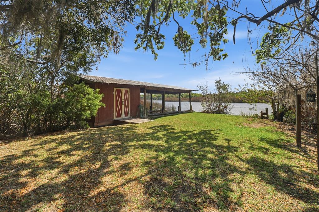 6491 Spruce Creek Road Port Orange, FL 32127 - Photo 50 of 73 a view of a house with backyard and tree