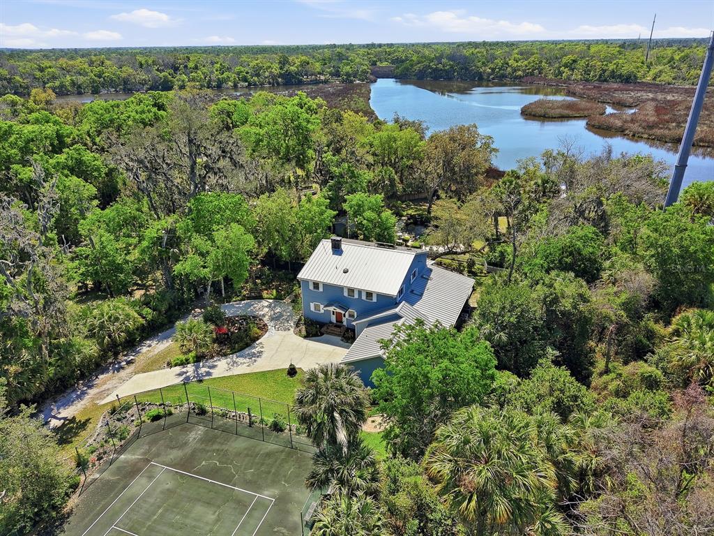 6491 Spruce Creek Road Port Orange, FL 32127 - Photo 56 of 73 an aerial view of a house with outdoor space and a lake view