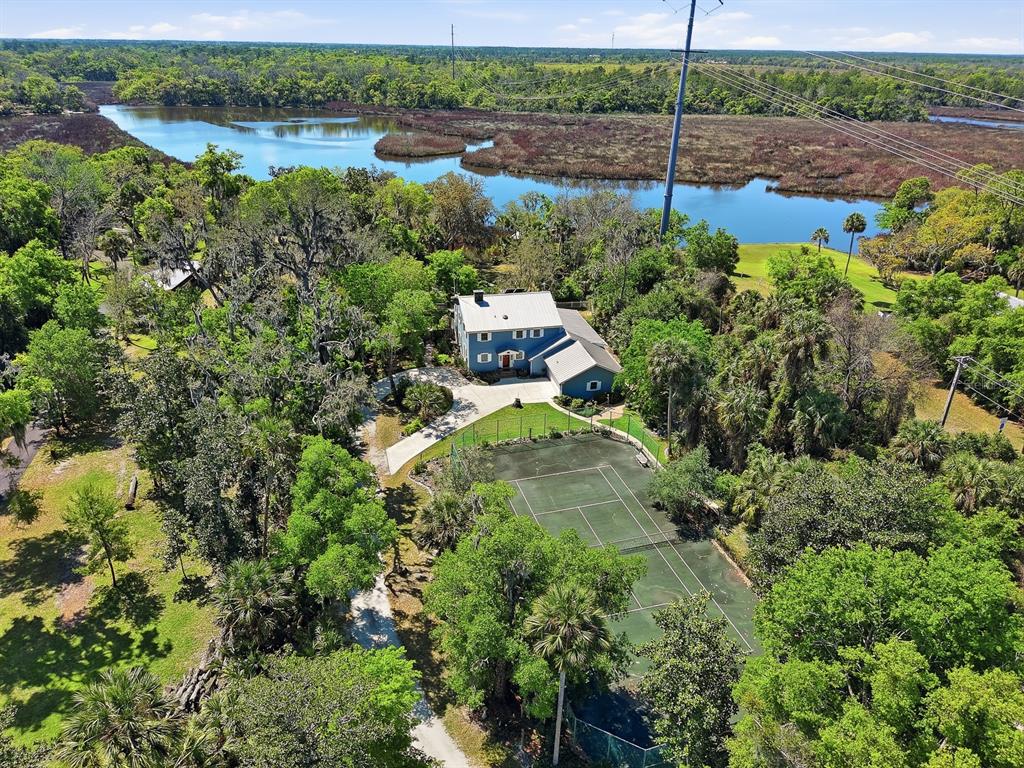 6491 Spruce Creek Road Port Orange, FL 32127 - Photo 59 of 73 an aerial view of a house with a yard and lake view