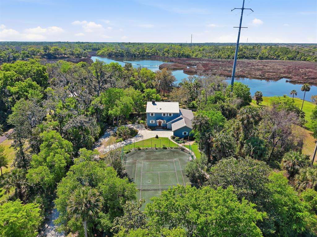 6491 Spruce Creek Road Port Orange, FL 32127 - Photo 60 of 73 a view of a garden with a lake