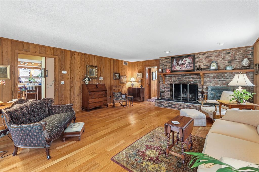 6491 Spruce Creek Road Port Orange, FL 32127 - Photo 6 of 73 a living room with furniture and a fireplace