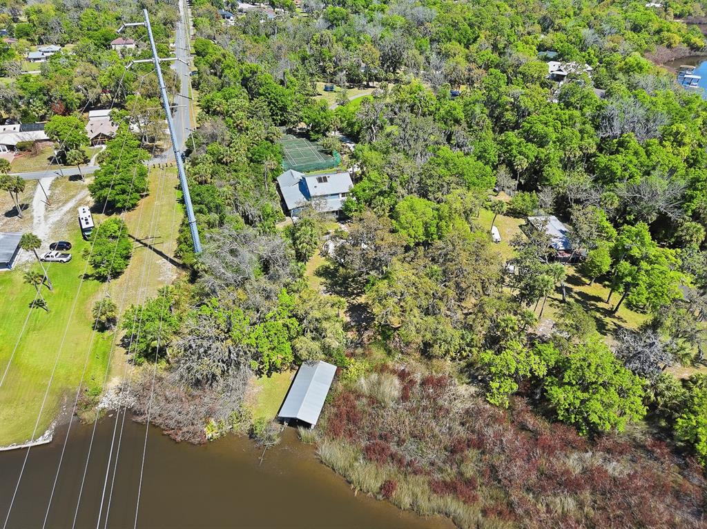 6491 Spruce Creek Road Port Orange, FL 32127 - Photo 63 of 73 a view of a yard with plants and wooden fence