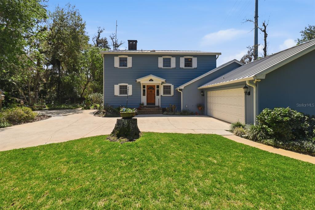 6491 Spruce Creek Road Port Orange, FL 32127 - Photo 66 of 73 a front view of a house with a yard