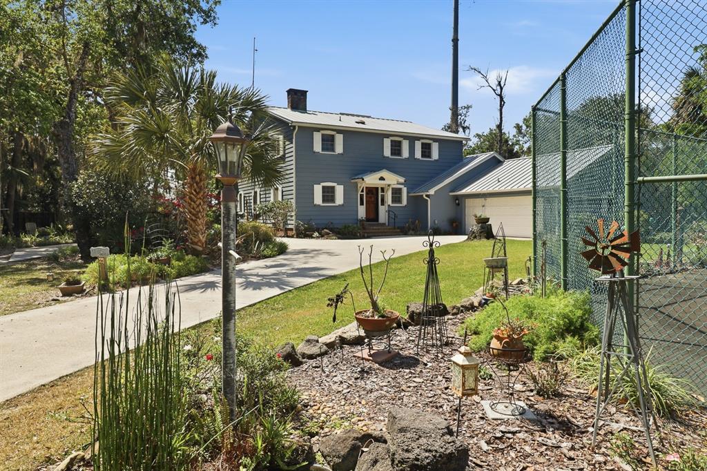 6491 Spruce Creek Road Port Orange, FL 32127 - Photo 67 of 73 a view of a house with backyard and sitting area