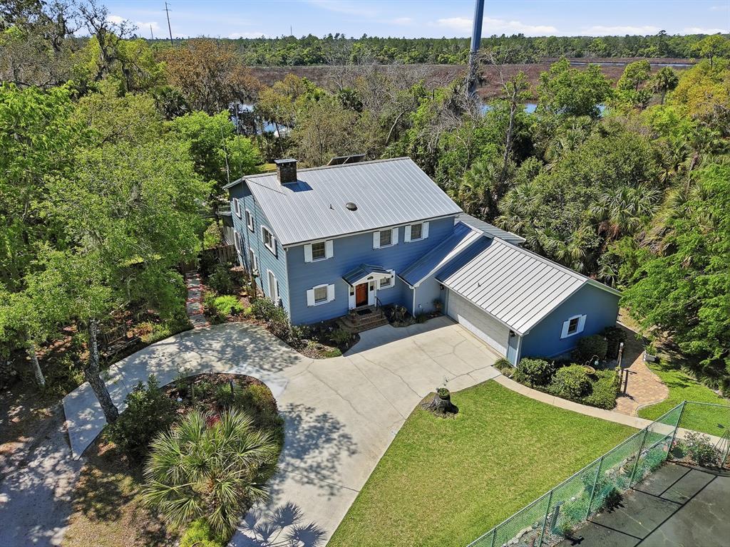 6491 Spruce Creek Road Port Orange, FL 32127 - Photo 68 of 73 an aerial view of a house with a garden