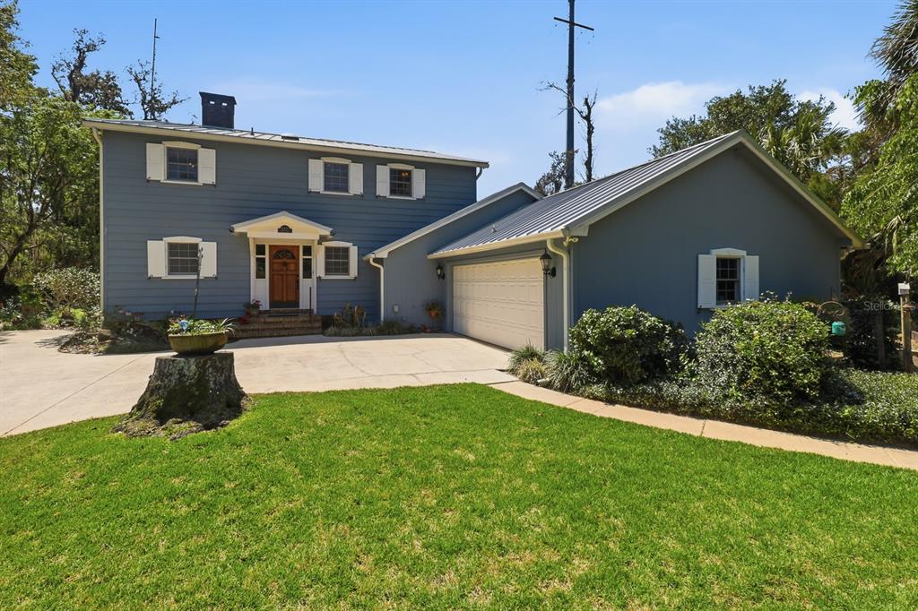 6491 Spruce Creek Road Port Orange, FL 32127 - Photo 70 of 73 a front view of a house with a yard