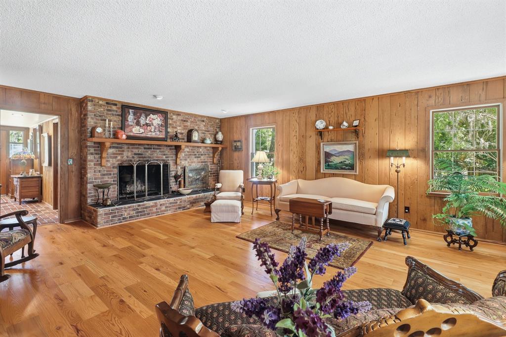 6491 Spruce Creek Road Port Orange, FL 32127 - Photo 7 of 73 a living room with furniture large window and a fireplace