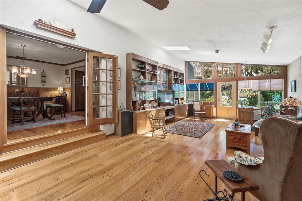 6491 Spruce Creek Road Port Orange, FL 32127 - Photo 9 of 73 a living room filled with furniture hardwood floor and a large window