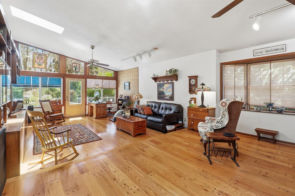 6491 Spruce Creek Road Port Orange, FL 32127 - Photo 10 of 73 a living room with furniture and large windows