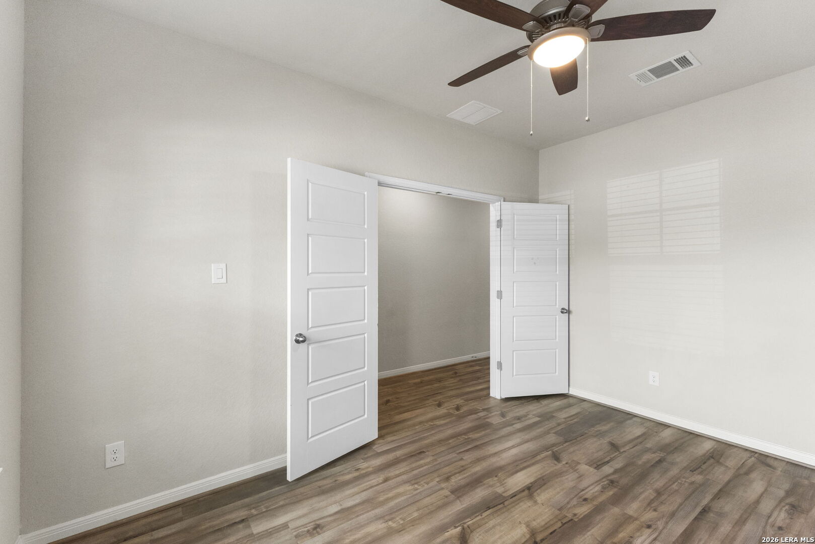12221 Icon Ridge San Antonio, TX 78253 - Photo 18 of 46 an empty room with wooden floor ceiling fan and windows
