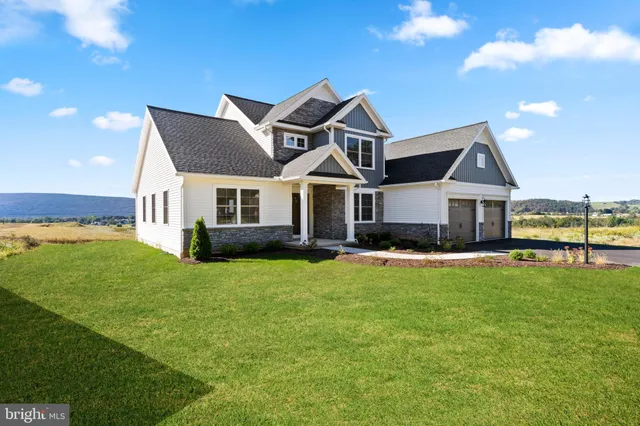 a front view of a house with a garden and yard