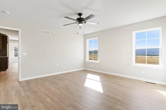 wooden floor in an empty room with a window