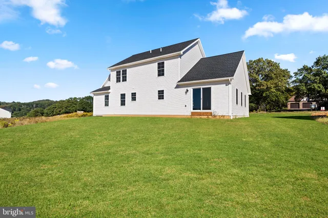 a house that has a big yard with wooden fence