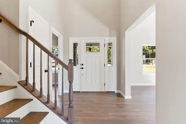 a view of an entryway with wooden floor