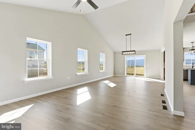 a view of a livingroom with wooden floor and a window