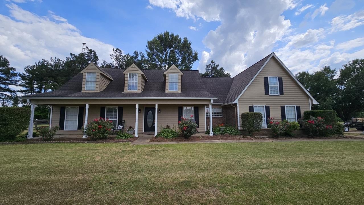 a front view of house with yard and green space