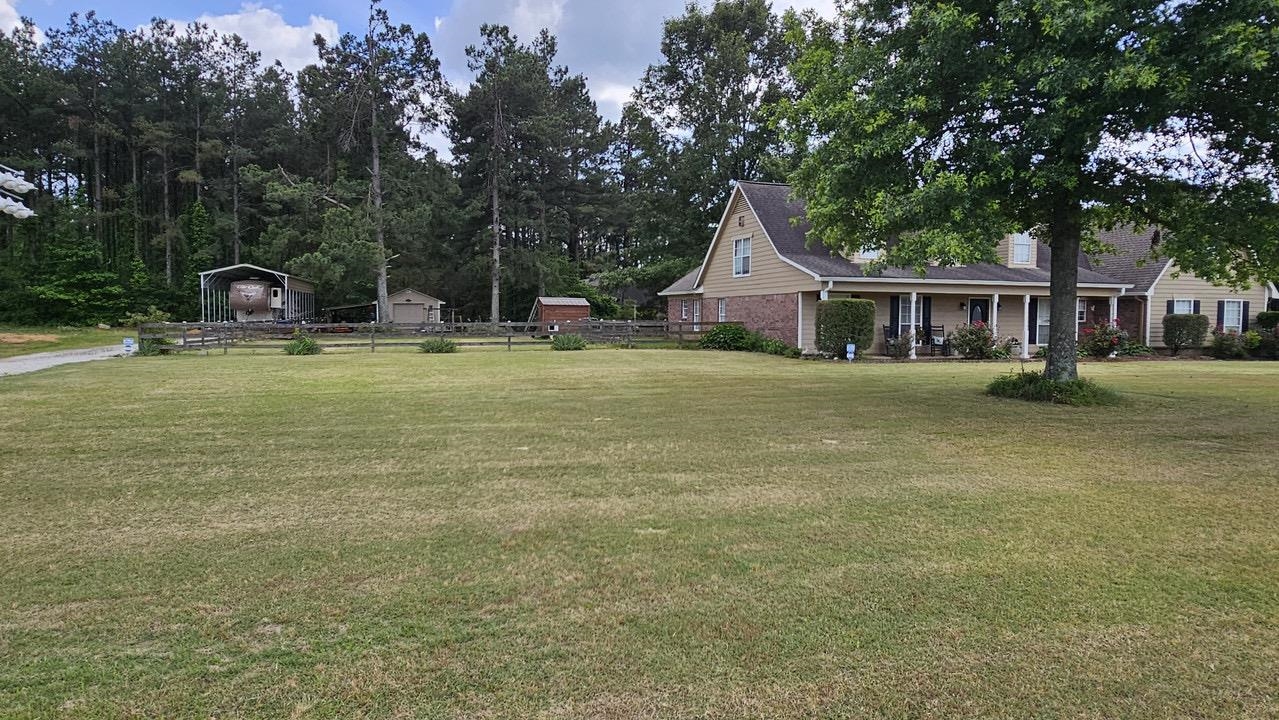 9919 Millington Arlington Road Arlington, TN 38002 - Photo 21 of 22 a front view of a house with a garden and trees