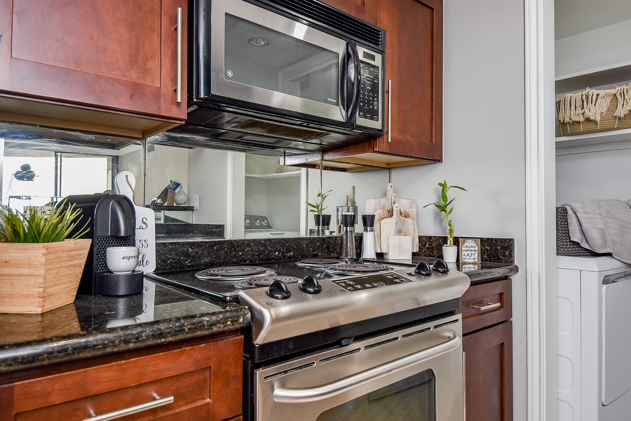 3525 Sage Road, Unit 1407 Houston, TX 77056 - Photo 11 of 34 a kitchen with stainless steel appliances granite countertop a sink a stove and a microwave
