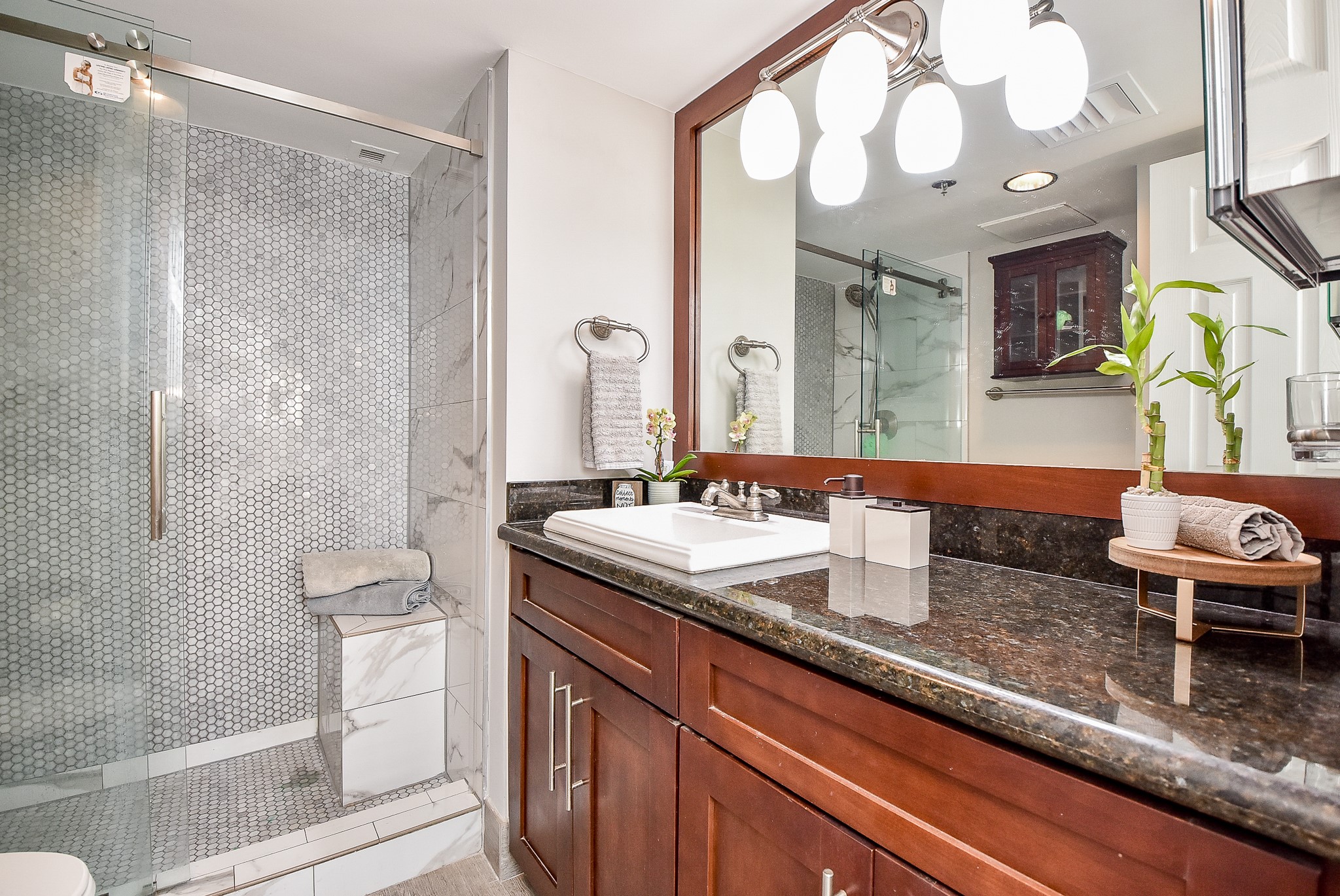3525 Sage Road, Unit 1407 Houston, TX 77056 - Photo 16 of 34 a bathroom with a granite countertop sink a toilet and a mirror