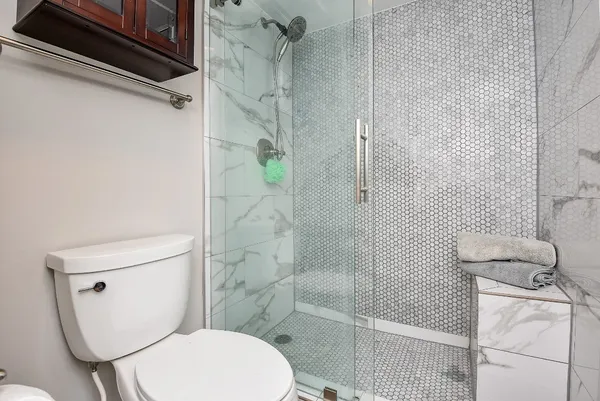 a white toilet sitting next to a bathroom sink