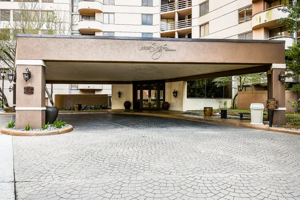 a view of a building with car parked