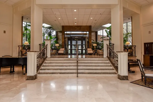 a room with pool table and chairs