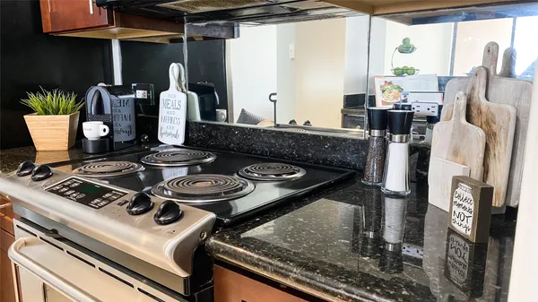 a stove top oven sitting next to a window