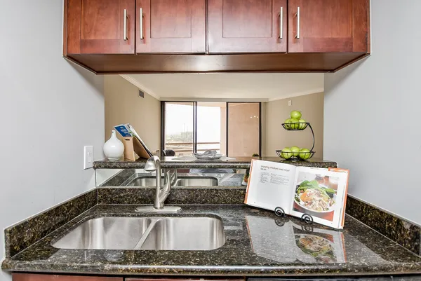 a kitchen with a sink a stove and cabinets