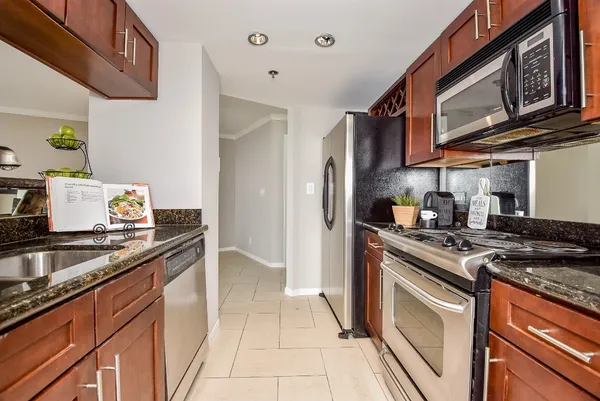a kitchen with stainless steel appliances granite countertop a stove and a sink